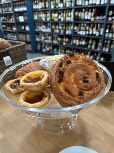 A selection of baked goods including sourdough, seeded sourdough, and rye loaves; large ciabattas, sensational rosemary focaccia, croissants (plain and almond), pain au chocolate, and truly authentic pastel de natas (Portuguese custard tarts). Now available at Vineyards wine shop in Sherborne